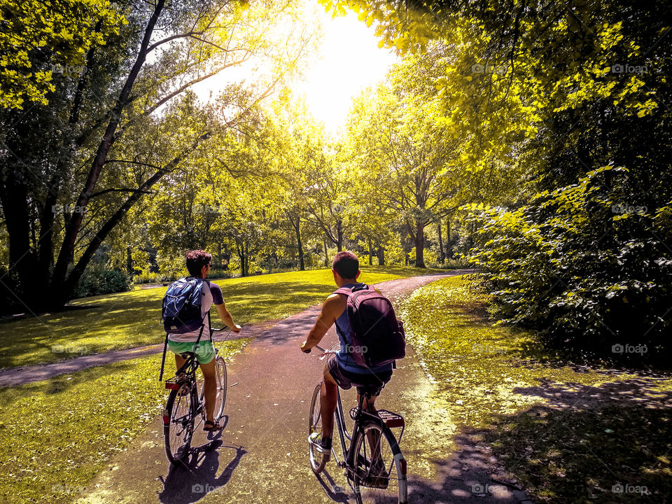 Couple of friends riding their bikes at the park