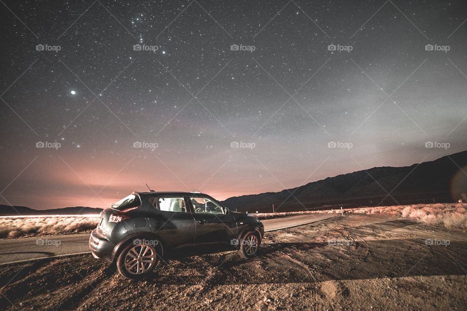 fast vehicle in an open field under a starry sky