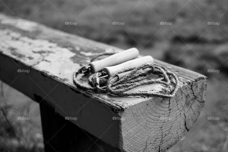 Children jump rope on bench