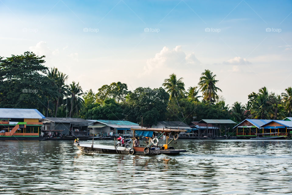 Ship passenger and motorbikes across  Khwae Noi river at Kanchanaburi Thailand.