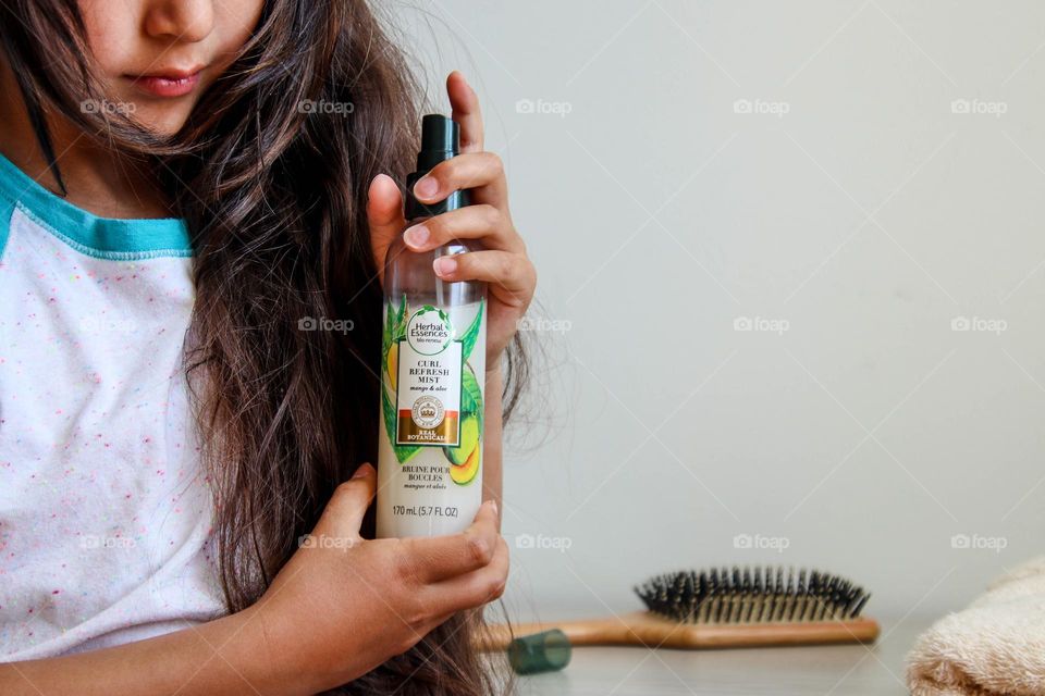 Girl with gorgeous long hair is using Herbal Essences hair solution