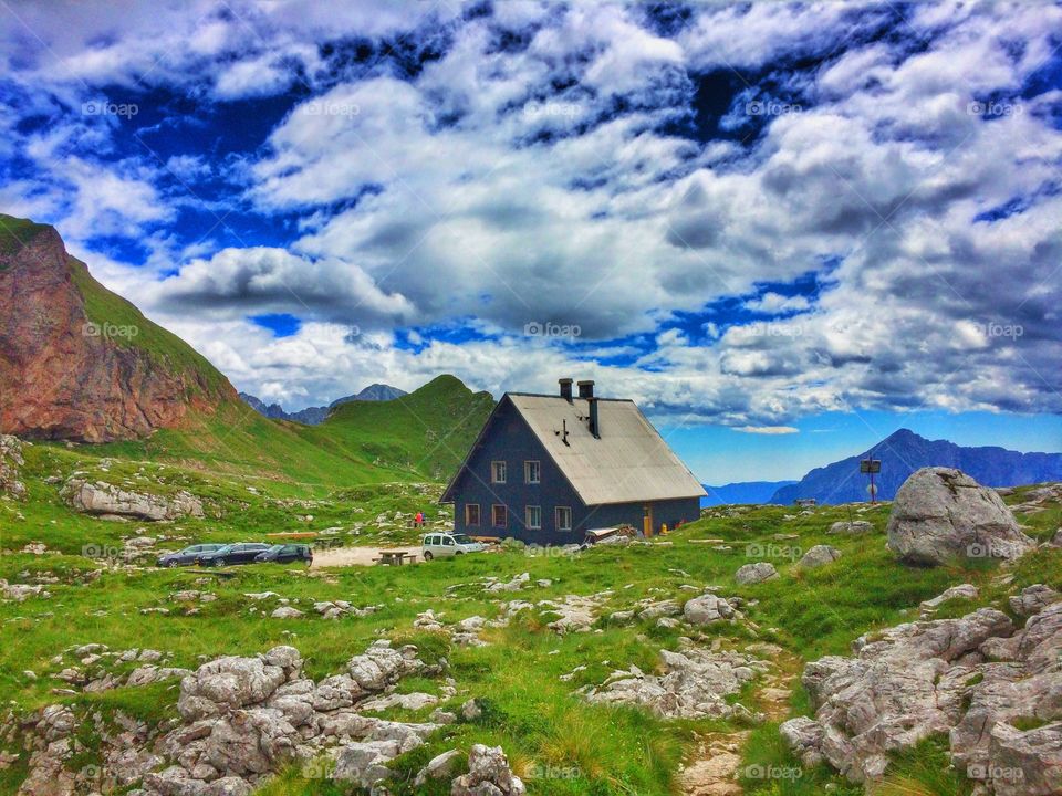 Cottage on mountain on sunny day