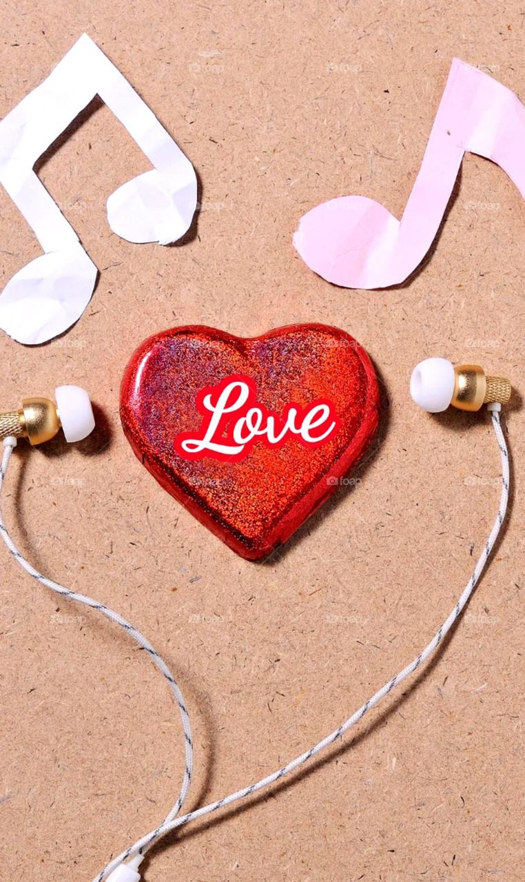 love symbol and ear buds arrange nice like a men lisent a song so nice click