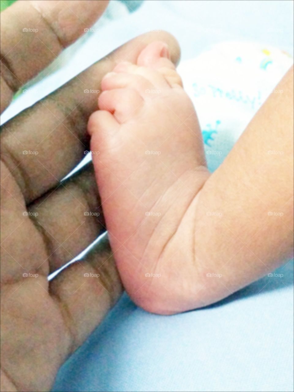 Foot in hand. Foot of newborn baby in mom"s hand