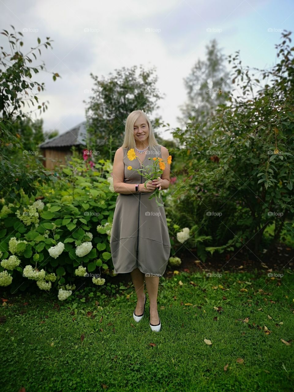 Mature adult woman holding flowers