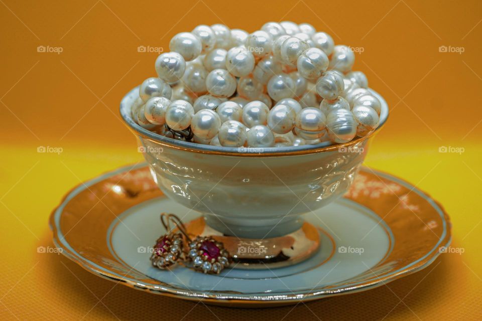 A tea cup and a jewelry