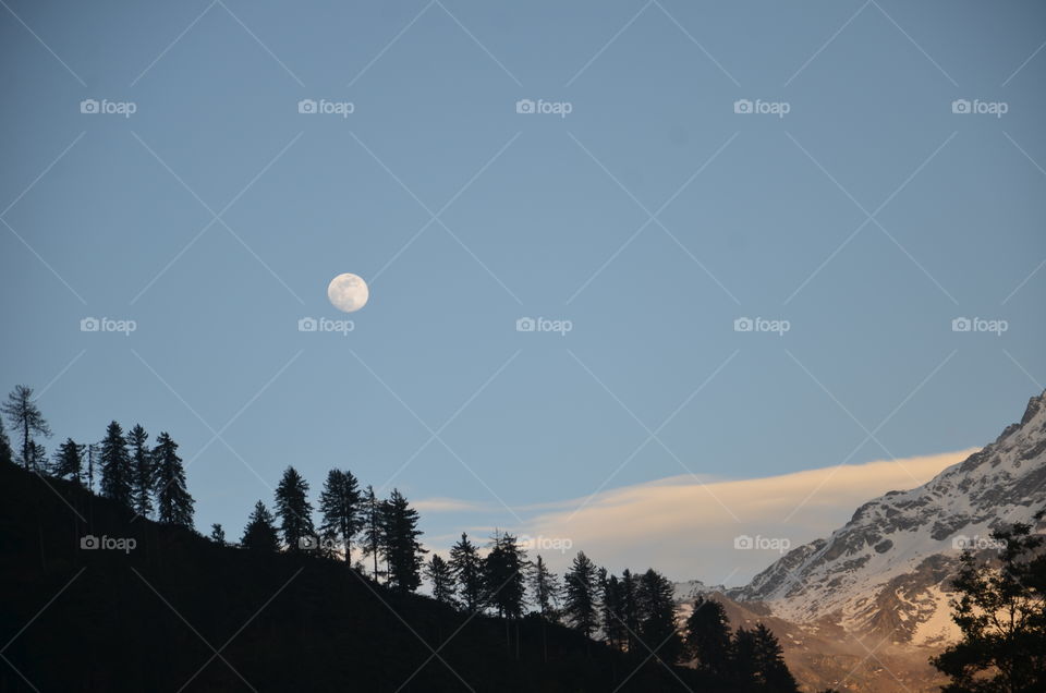 moon with sunlight rays on icy mountain
tosh beauty