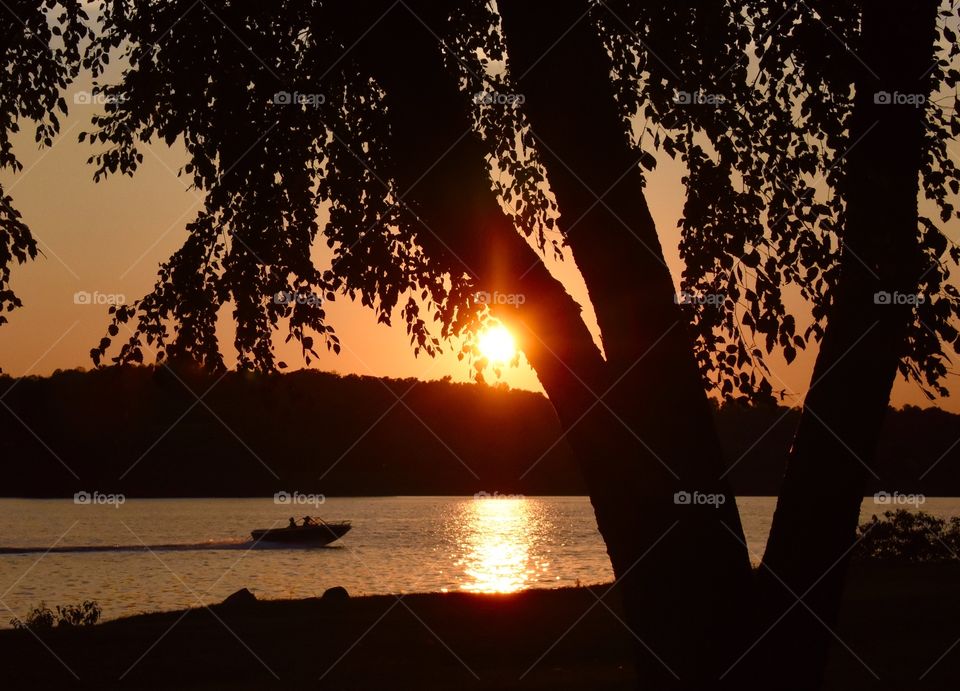 Evening boat ride as the golden sun reflects on the lake