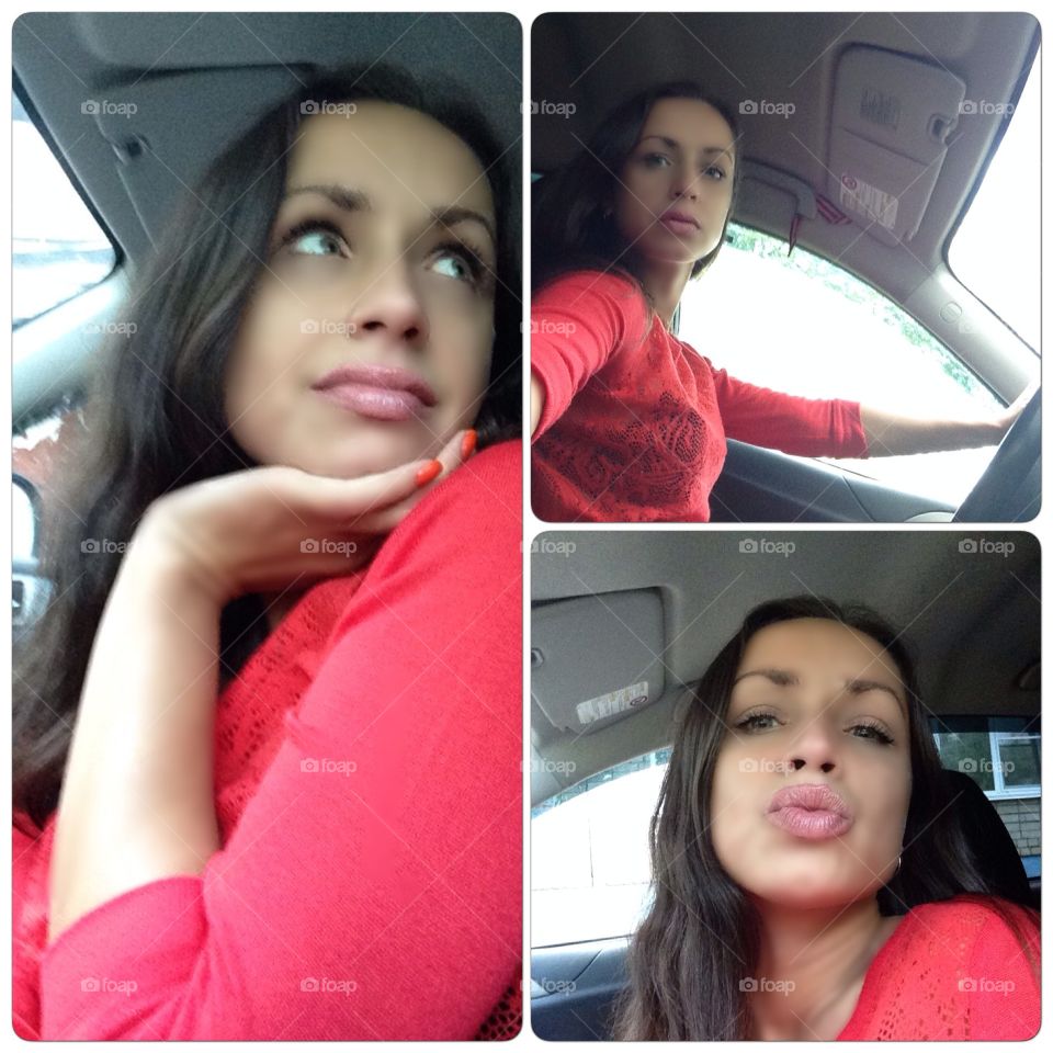 The brunette girl in a red sweater in the car.