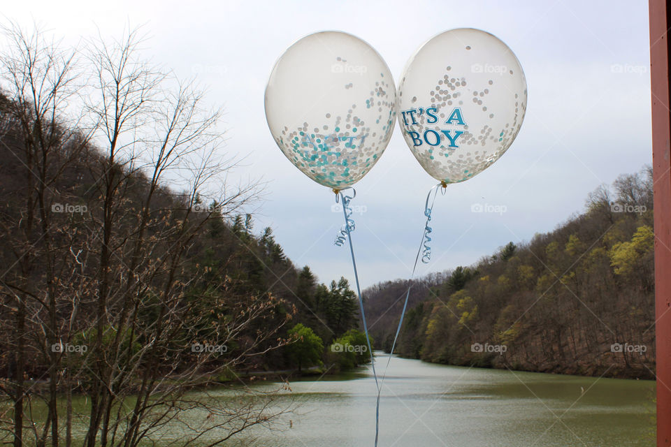 Celebrating a baby boy coming soon with confetti balloons. 
