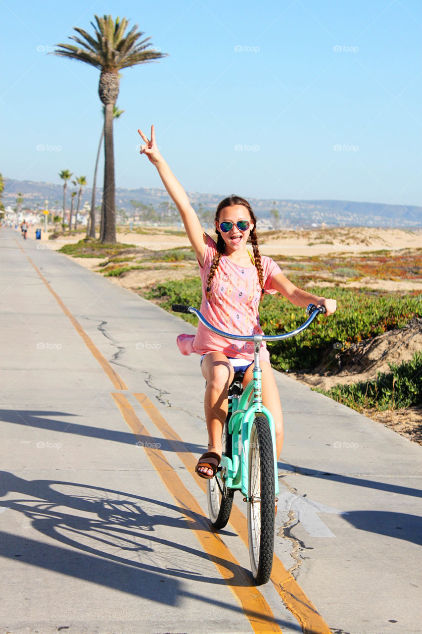 Girl gesturing while cycling