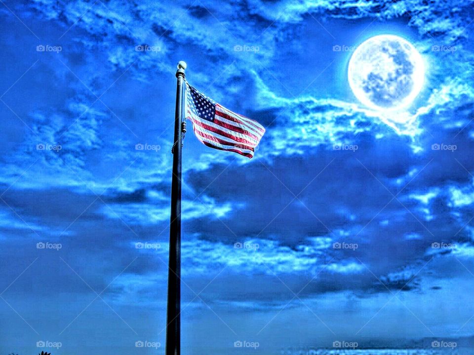 a moonlit flag Standing Tall in the night sky