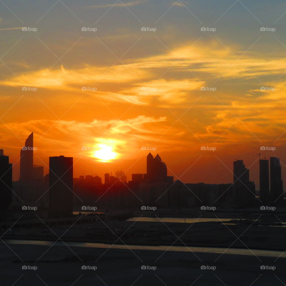 Beautiful sunset on Reem Island with fluffy clouds.