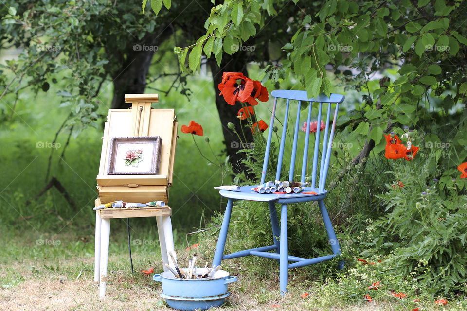red poppy, blue chair and painted painting