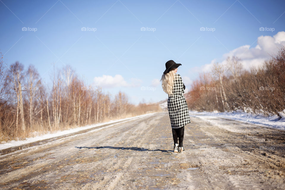 Rear view of a women walking on road