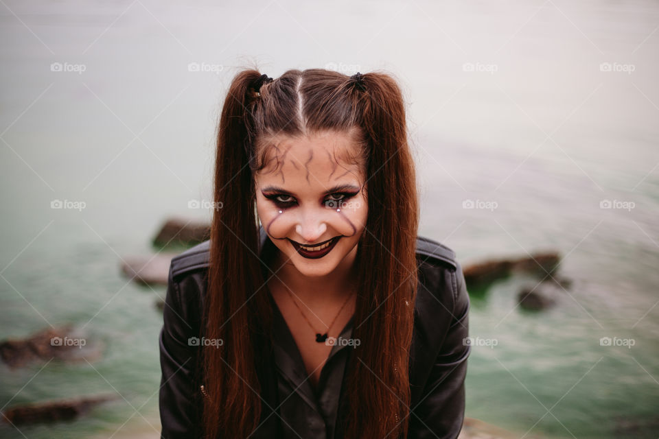 woman with halloween makeup with scary smile on her face