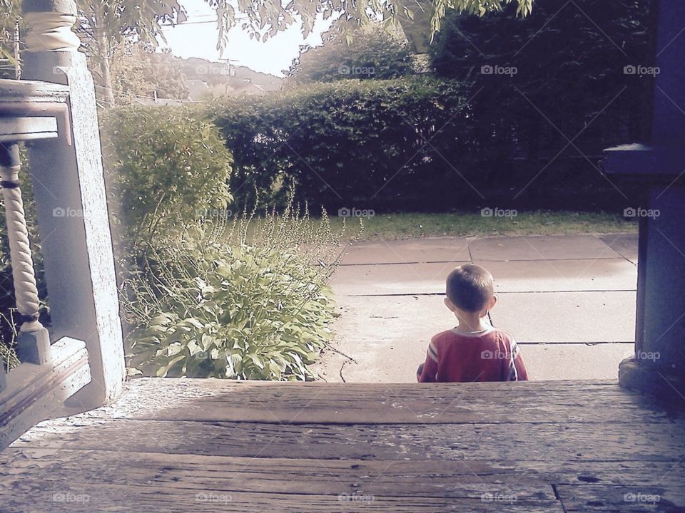 Boy Sitting on Porch 