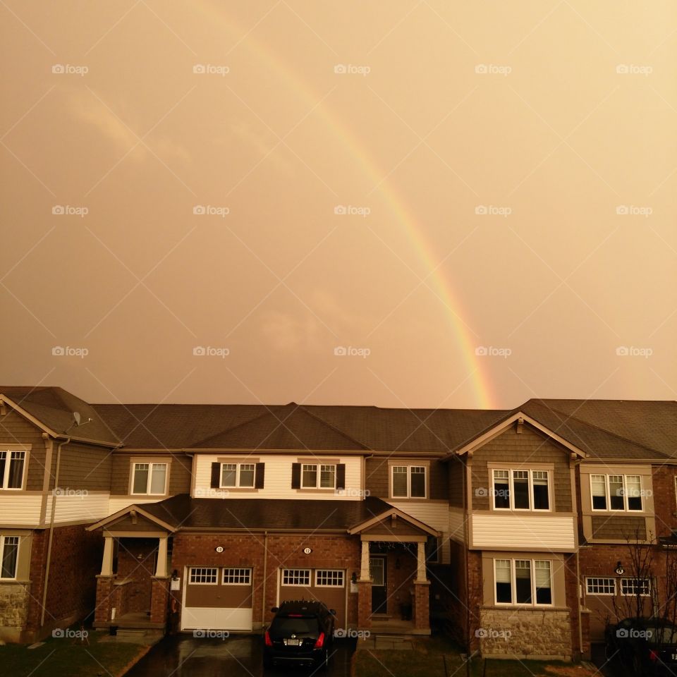 rainbow over houses
