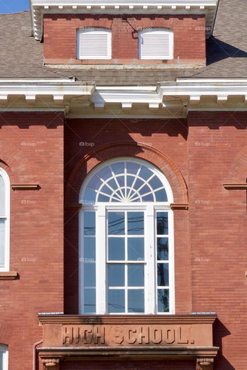 Architectural detail over what used to be the entrance to a high school, now converted to an apartment building