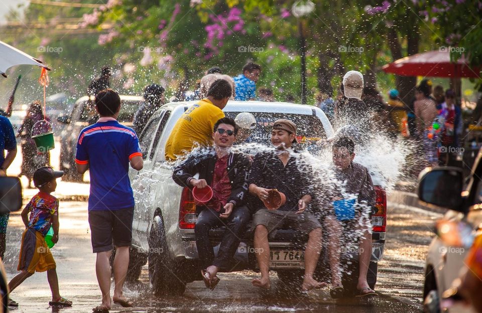 Summer time is coming . Songkran festival in Chiang Mai, thai new year. People playing water on main road