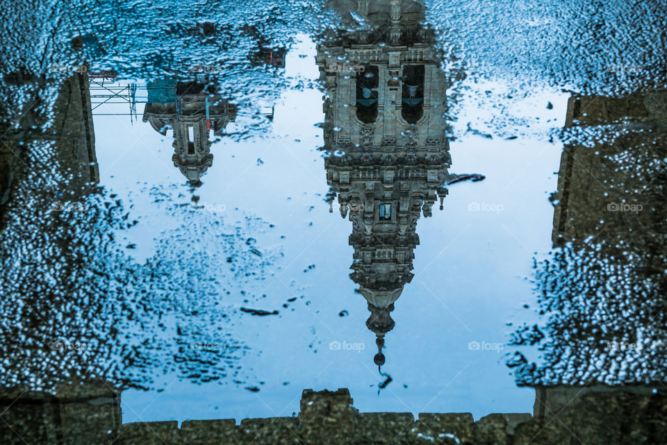 Cathedral tower reflected in a water puddle, Santiago de Compostela