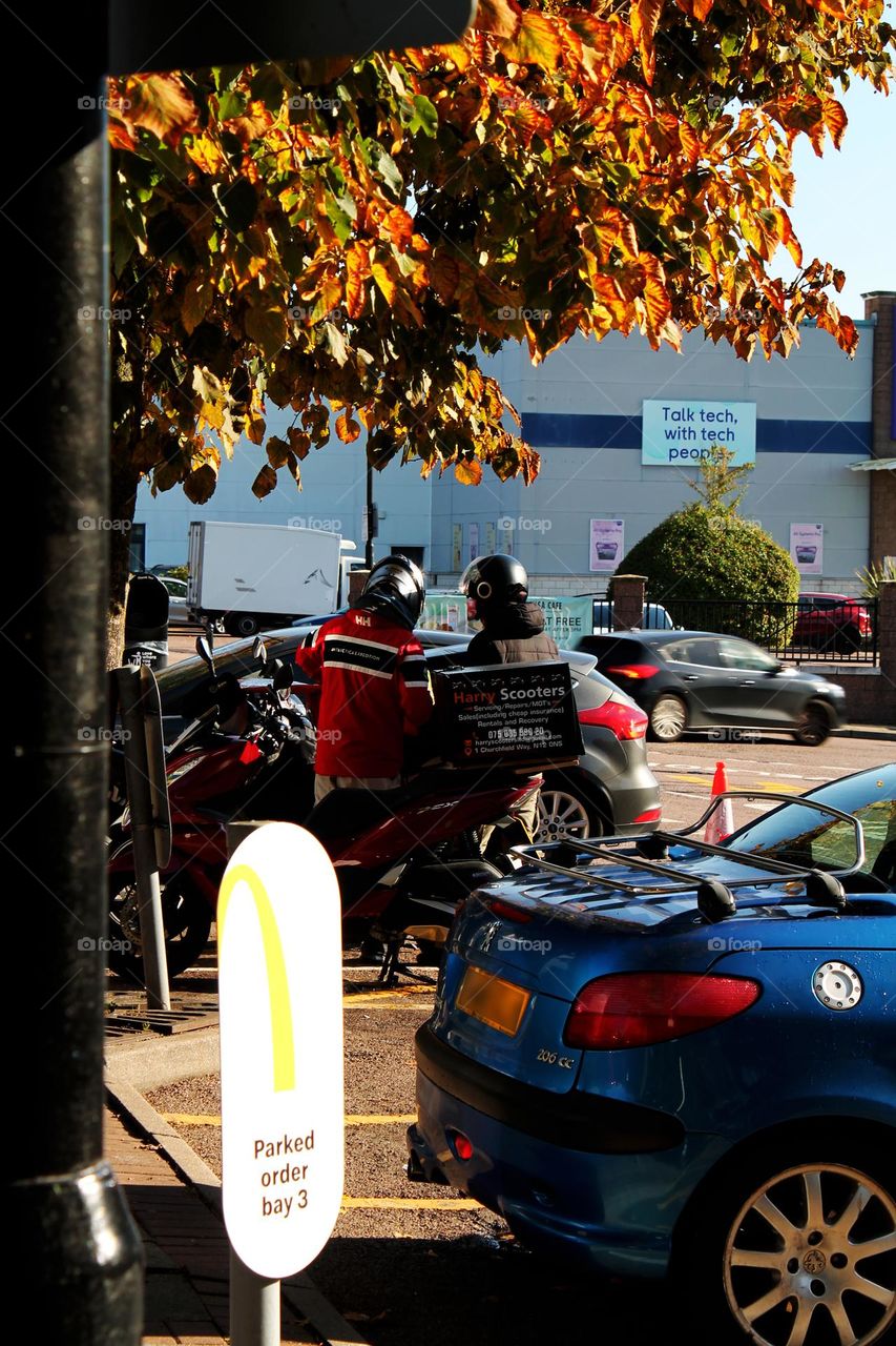 Two motorcyclists talking, street photography