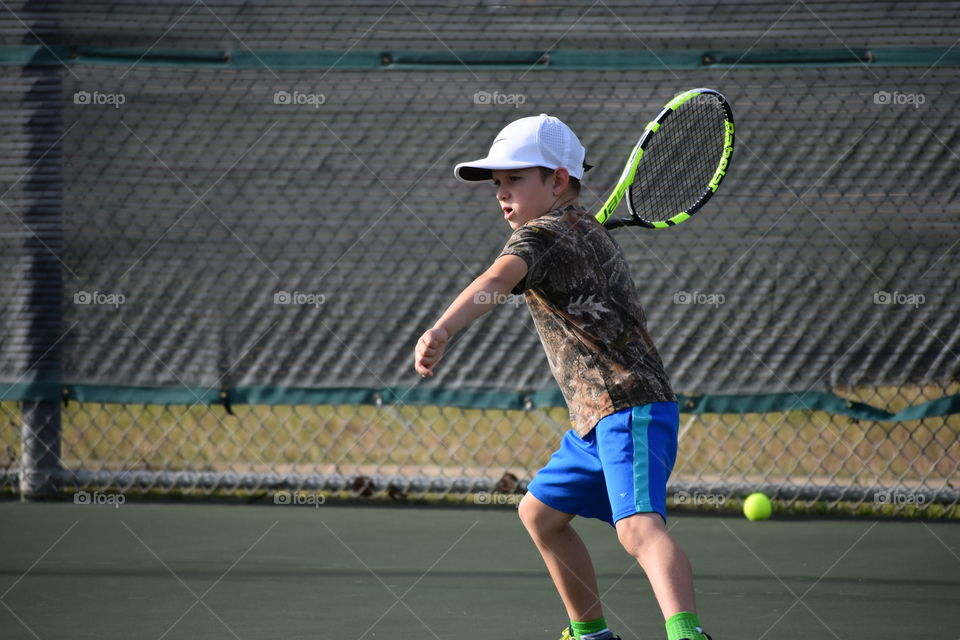 Close-up of a boy playing tennis