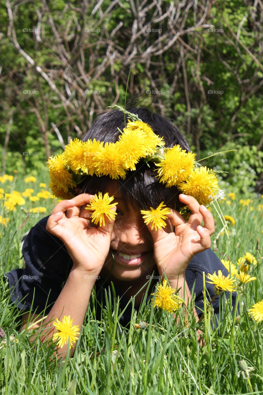 Close-up of a child with yellow flowers