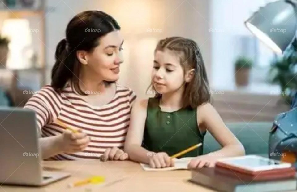 A mother learn her daughter study and prepare a lesson nice mother and her daughter photo