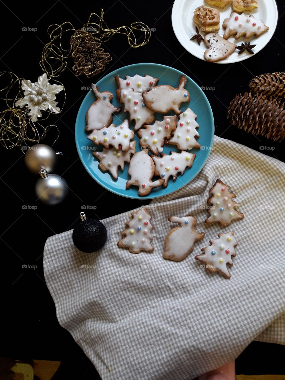 Home made Christmas cookies with blue plate on black table