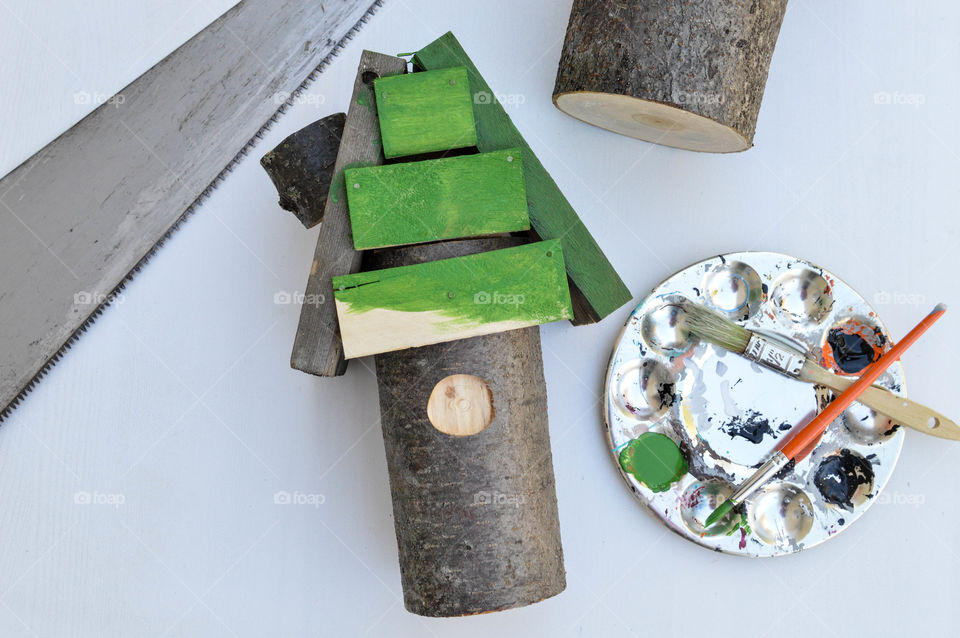 Making a decorative birdhouse with wood, saw and paint sitting