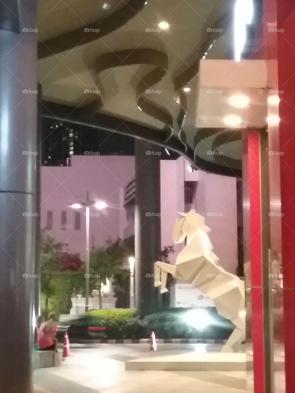 A white horse is about to fly in front of Gateway, Ekamai, Bangkok, Thailand.
