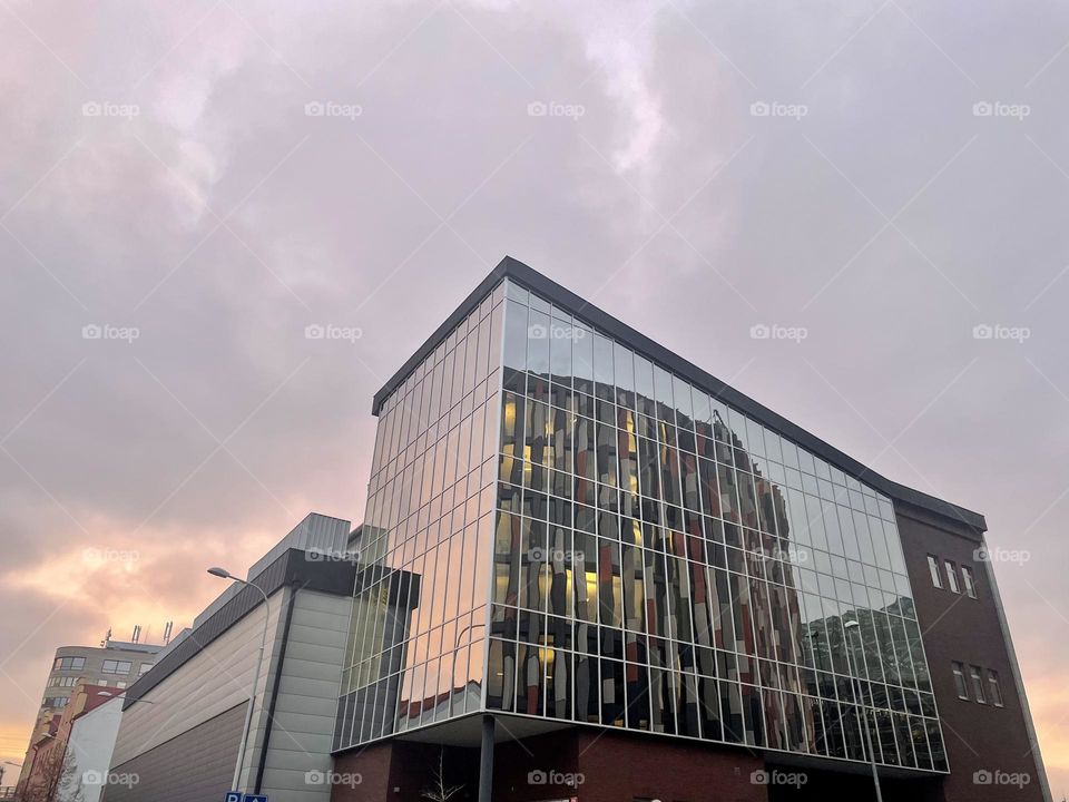 Reflection of the Main Point Karlin office building at dusk in the glass facade of the neighbouring building in Prague, Czech Republic.