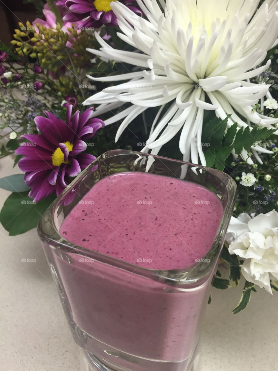 Berry smoothie with flower background
