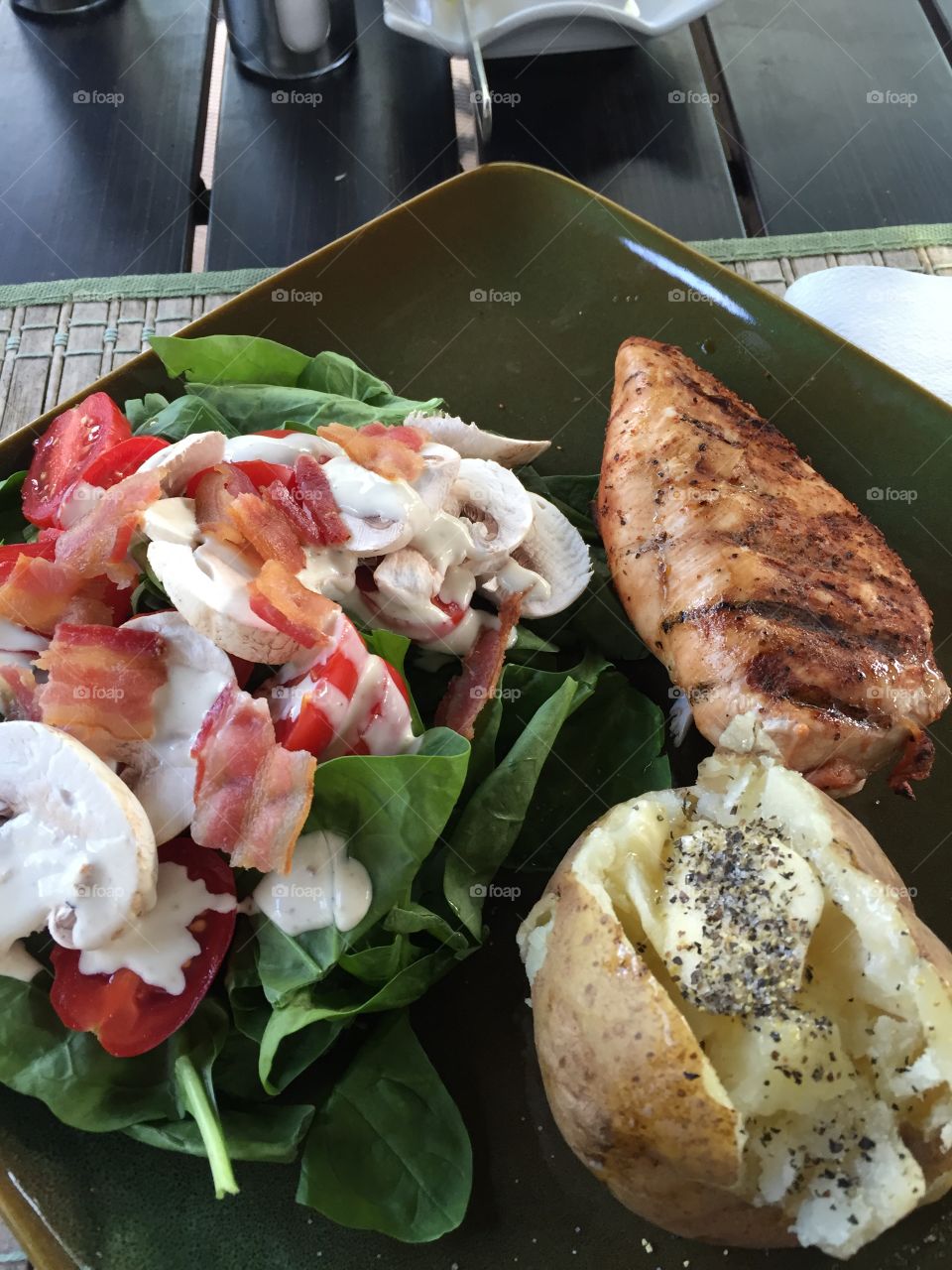 Grilled Chicken Breast, Caesar salad with bacon and a baked potatoes 
