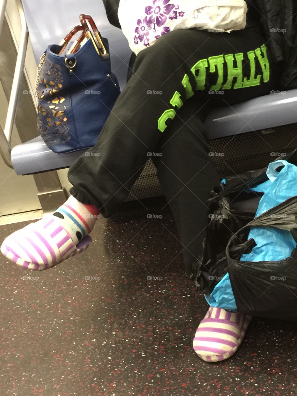 Slipper-ing on the Subway. Woman, relatively clean, wearing her most comfortable shoes on the Manhattan subway.