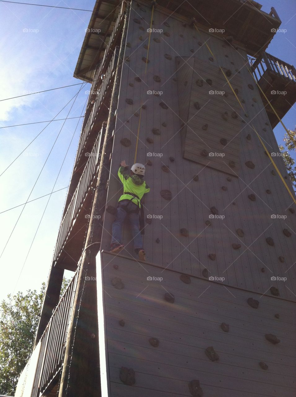 Boy rock wall climbing 