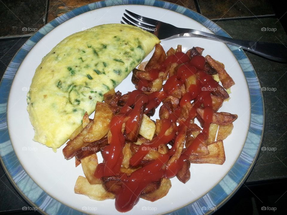breakfast omelette with spinach and home fries with ketchup