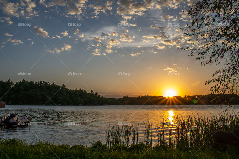 Sunset with clouds over a lake in Minnesota in June