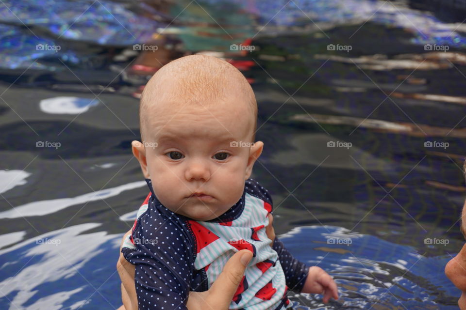 Close-up of a cute toddler in lake