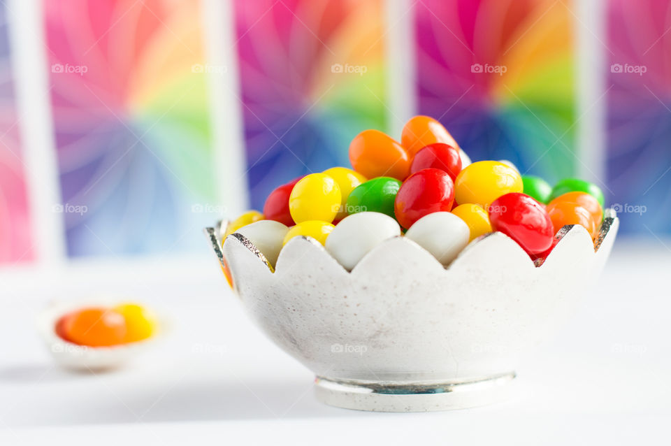 A bowl full of colourful sugar candies.