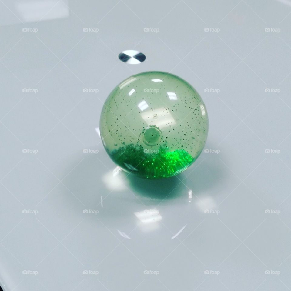 Glitter ball toy on a glass table