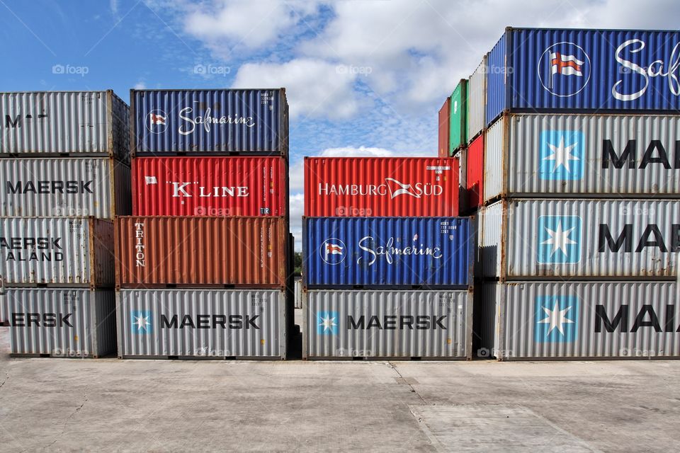 Shipping and cargo containers stacked up in rows.