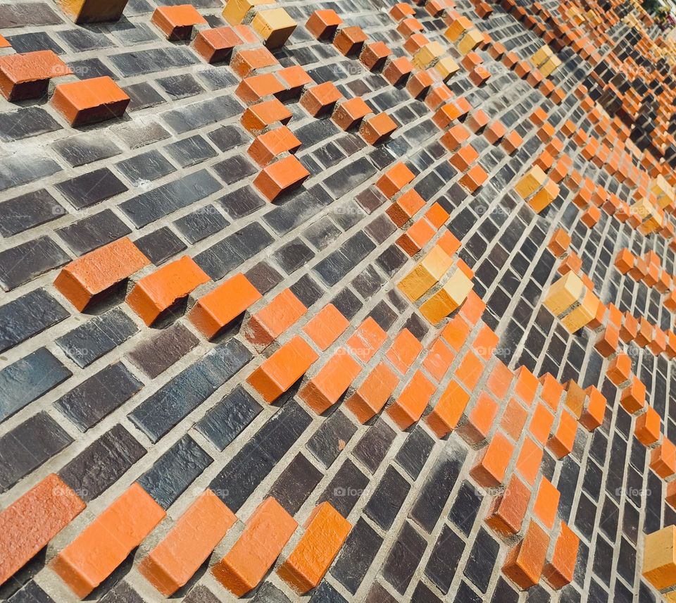 Close up of a brick wall with three-dimensional rendition of crosses