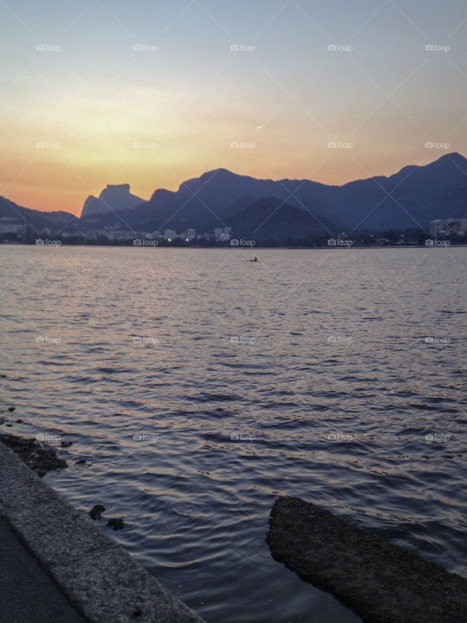 View of a lake ,with mountains  and a beautiful sunset 