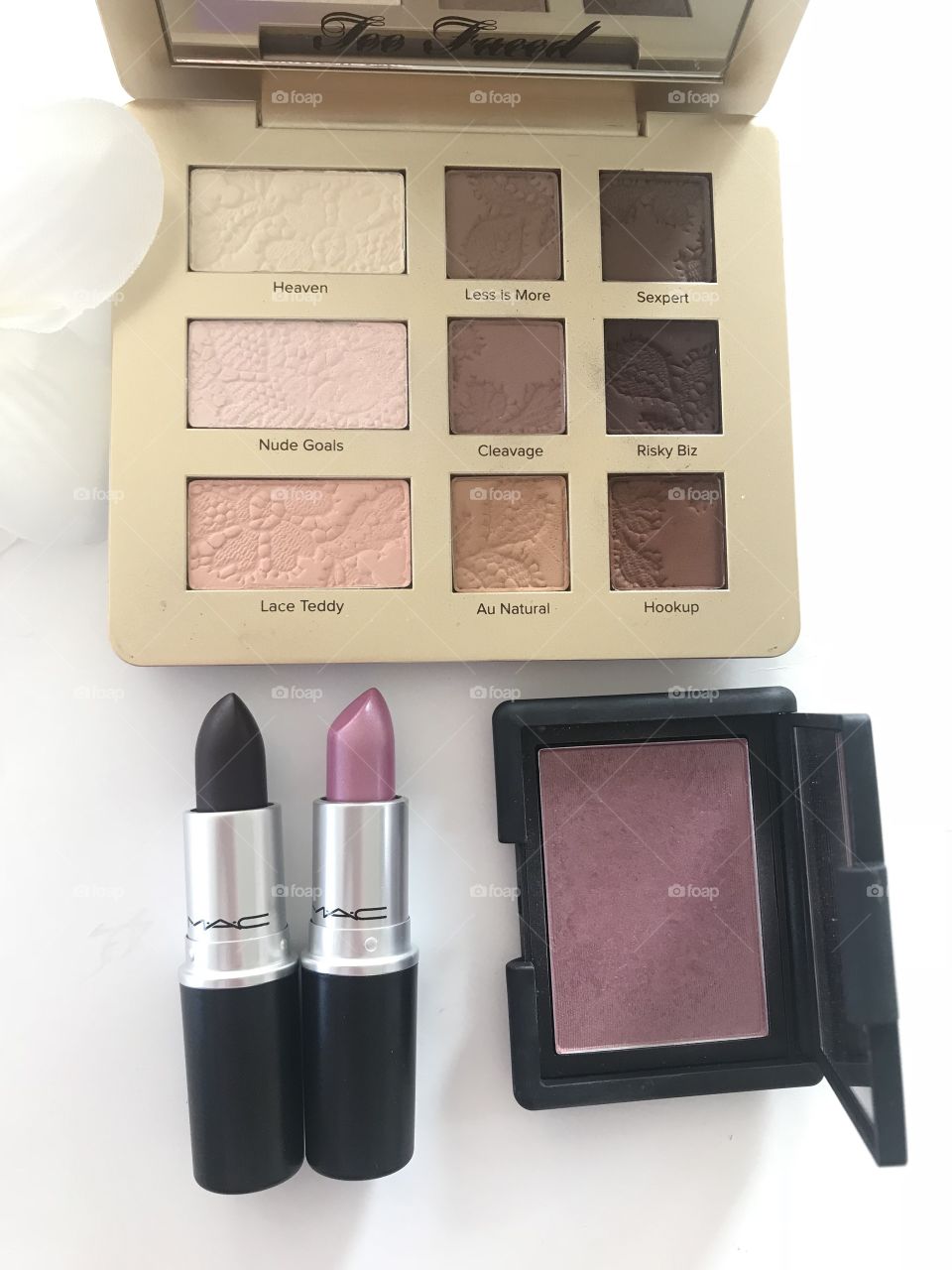 Makeup flat lay lipstick, eyeshadow and blush 