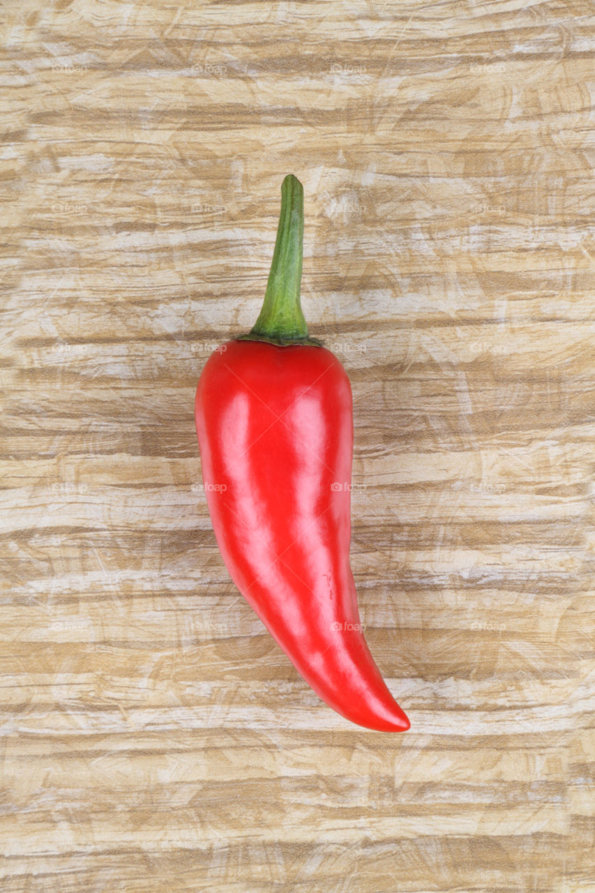 Red chili on wooden background