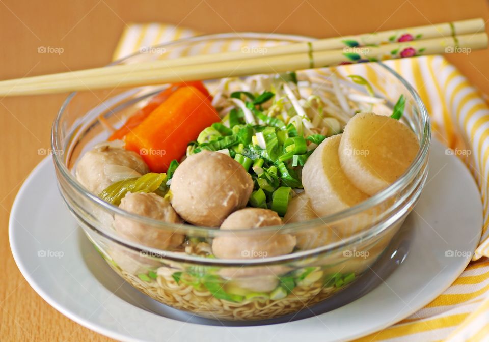 Homemade delicious rice noodle soup with pork ball and vegetables.