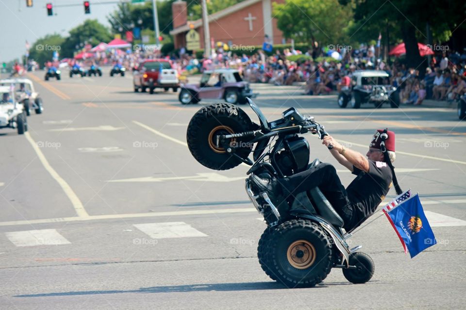 Wheelie in Parade. Watching the Liberty Fest Parade in Edmond, OK, saw this Indian Shriner stop and do a wheelie, they loved it!!