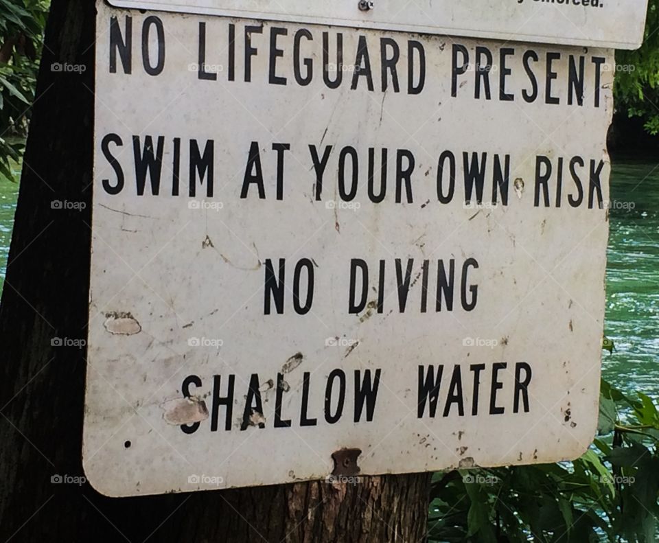 Swim at your own risk sign 